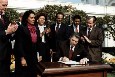 1280px-Reagan_signs_Martin_Luther_King_bill